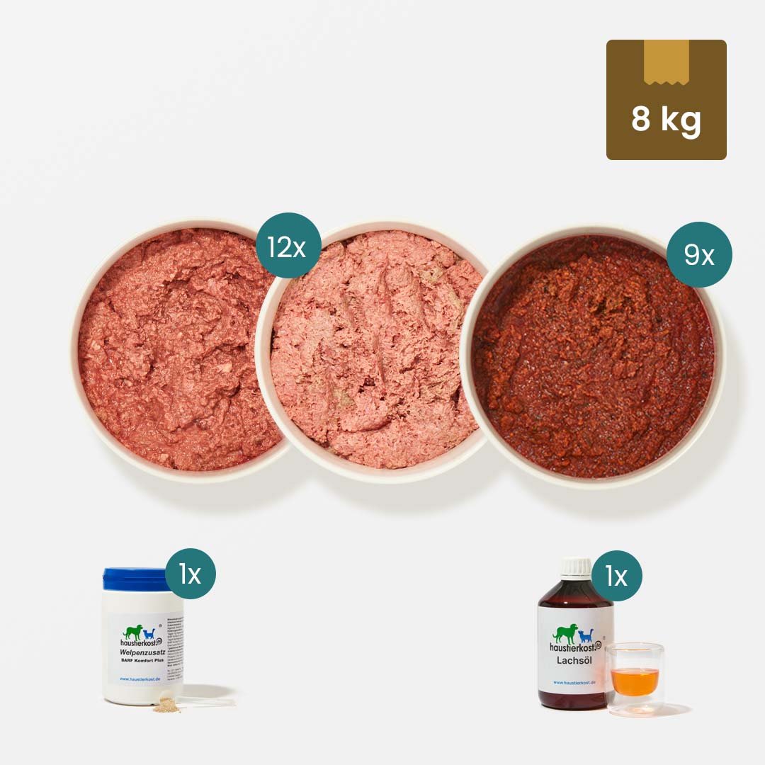 WelpenBox Menü 2 mit 8 kg Welpenfutter, Truthahnfleisch, Obst-Gemüse-Mischungen, Welpenzusatz und Lachsöl, alles in Portionsschalen und Flaschen.