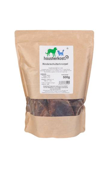 Rinderschulterknorpel getrocknet, 500 g natural dog chew in a sealed brown bag with label for dental care.